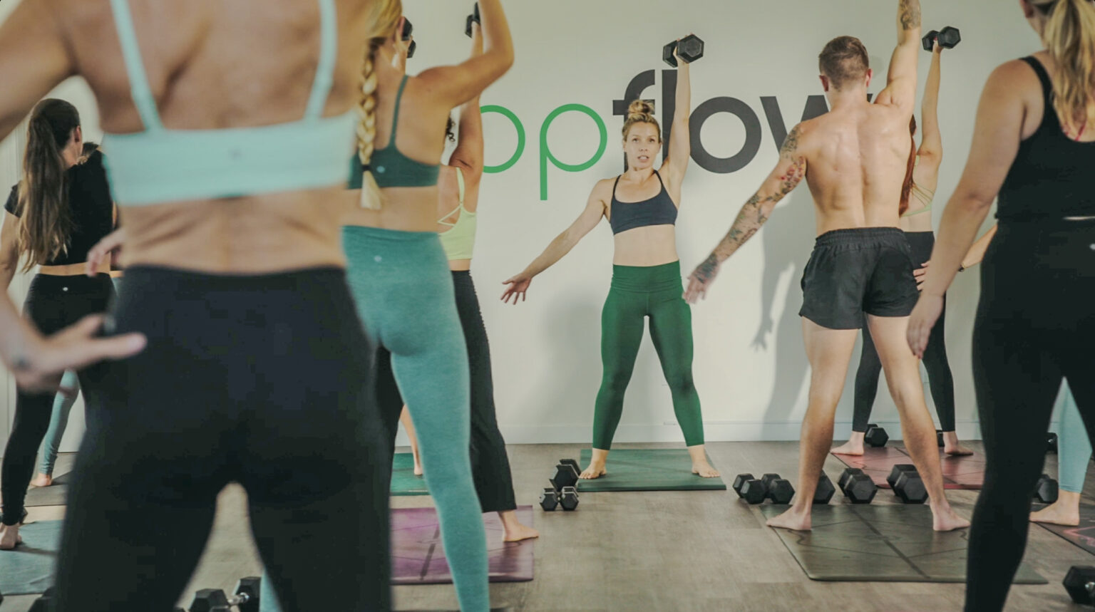 San Diego Fitness instructor leading class at Popflow Studios.